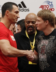 Heavyweight boxing world champion Vladimir Klitschko of Ukraine shakes hands with challenger Alexander Povetkin of Russia during an official weigh-in on the eve of their title fight in Moscow