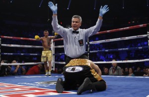 Lomachenko stands in his neutral corner as referee Mora calls the fight after Lomachenko stopped Ramirez in the 4th round of their featherweight fight in Las Vegas